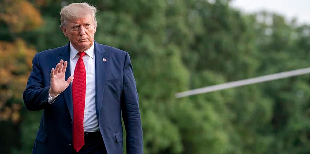 President Trump walking and waving at someone off frame